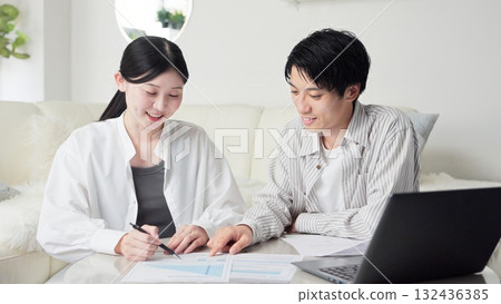 Asian couple considering insurance Asian couple considering insurance 132436385
