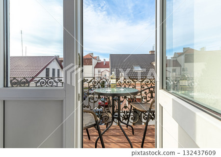 Elegant Balcony with Wine and Scenic European Rooftops 132437609