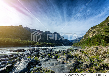 River Valley with a rocky bank and Picturesque Mountain Views River Valley with a rocky bank and Picturesque Mountain Views 132440317