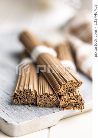 Buckwheat soba noodles on white table. Buckwheat soba noodles on white table. 132440418