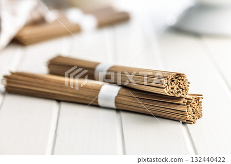 Buckwheat soba noodles on white table. Buckwheat soba noodles on white table. 132440422