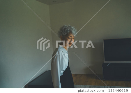 站在家裡客廳裡的老年婦女 132440619