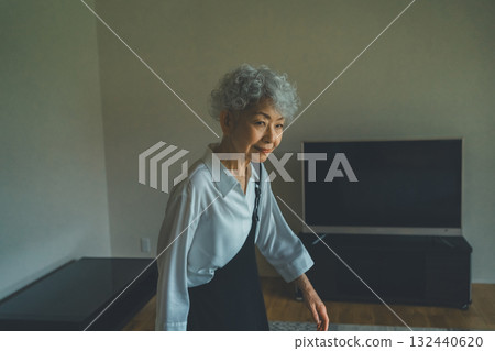 Senior woman standing in the living room at home Senior woman standing in the living room at home 132440620