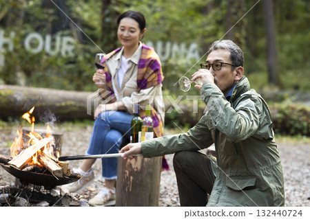 Family having a bonfire at a campsite Family having a bonfire at a campsite 132440724