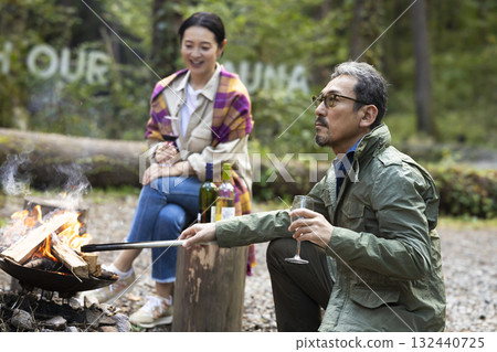 Family having a bonfire at a campsite Family having a bonfire at a campsite 132440725