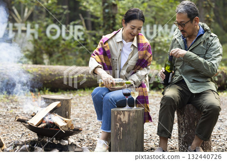 Family having a bonfire at a campsite Family having a bonfire at a campsite 132440726