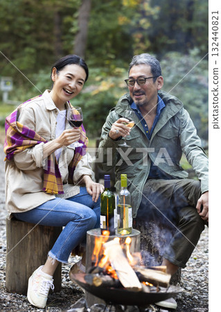 Family having a bonfire at a campsite Family having a bonfire at a campsite 132440821
