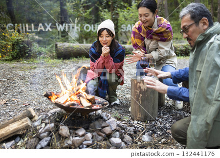 Family having a bonfire at a campsite Family having a bonfire at a campsite 132441176
