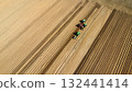 Aerial View of Tractors Preparing Farmland for Planting Season 132441414