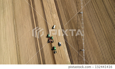 Aerial View of Tractors Preparing Farmland for Planting Season 132441416