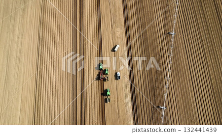 Aerial View of Tractors Preparing Farmland for Planting Season 132441439