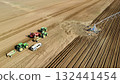 Aerial View of Tractors Preparing Farmland for Planting Season 132441454