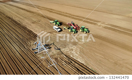 Aerial View of Tractors Preparing Farmland for Planting Season 132441470