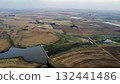 Aerial View of Tractors Preparing Farmland for Planting Season 132441486