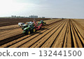 Aerial View of Tractors Preparing Farmland for Planting Season 132441500