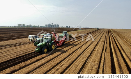 Aerial View of Tractors Preparing Farmland for Planting Season Aerial View of Tractors Preparing Farmland for Planting Season 132441500