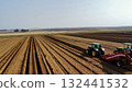 Aerial View of Tractors Preparing Farmland for Planting Season 132441532