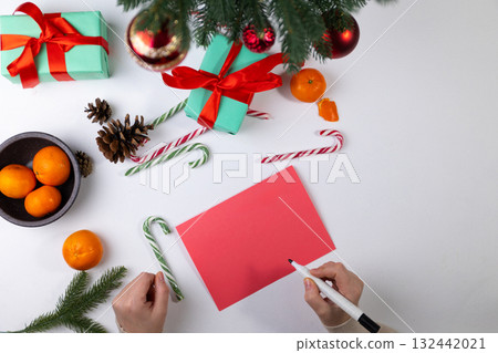 Holiday Greeting Card Preparation With Gifts and Tangerines 132442021