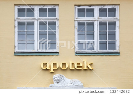 Pharmacy sign on a wall called apotek in Danish language 132442682