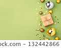 Christmas gift with ornaments on a green background 132442866