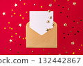 An empty white postcard in a covert on a red background 132442867