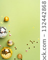 Christmas gold ornaments on a green background. 132442868