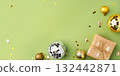 Christmas gift with ornaments on a green background 132442871
