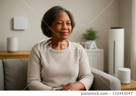 AI generated senior woman relaxing in a modern smart home with eco-friendly devices. The setting highlights comfort, automation, and smart technology for seniors enhancing everyday living. 132443047