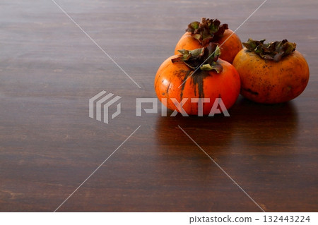 Discounted persimmons on the table Discounted persimmons on the table 132443224