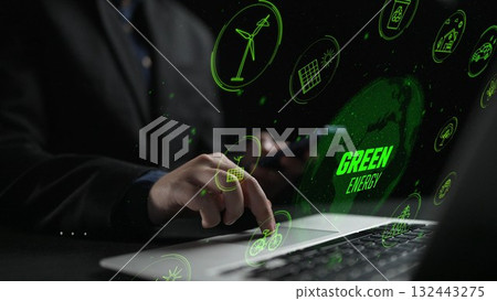 Modern Businessman Engaged in Green Energy Innovations with Digital Icons on Laptop Signifying Sustainable Technology Solutions Cipher 132443275
