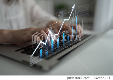 Hands typing on laptop keyboard with digital financial graph showing upward trend, data analytics, investment growth, and market analysis concept Scalp 132443281