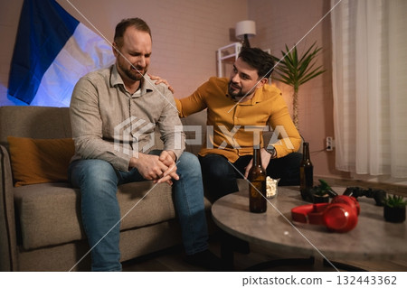 Emotional support during a difficult moment shared between two friends in a cozy living room Emotional support during a difficult moment shared between two friends in a cozy living room 132443362
