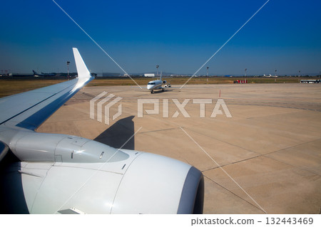 Airplane wing in airport with aircraft background Airplane wing in airport with aircraft background 132443469