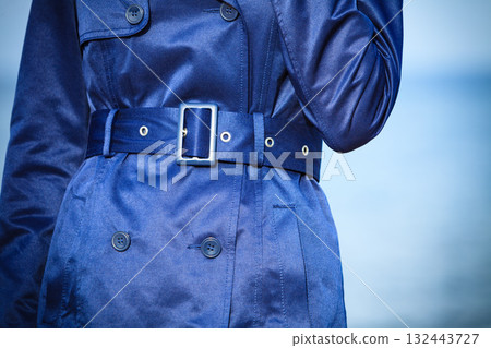 Female fashion. Closeup blue coat wit belt Female fashion. Closeup blue coat wit belt 132443727
