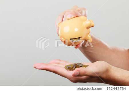 Male hands with coins and piggybank Male hands with coins and piggybank 132443764