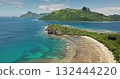 Fiji, Kuata island: Breathtaking aerial view of crystal clear turquoise water lagoon, vibrant coral reefs, wild sand beach, and lush vegetation. Green mountains under blue sky. Drone flight Fiji, Kuata island: Breathtaking aerial view of crystal clear turquoise water lagoon, vibrant coral reefs, wild sand beach, and lush vegetation. Green mountains under blue sky. Drone flight 132444220