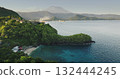 Aerial view secluded Bali Blue Lagoon beach with lush green hills, traditional coastal villages and tranquil turquoise water framed by Mount Agung. Tropical island landscape. Drone flight footage Aerial view secluded Bali Blue Lagoon beach with lush green hills, traditional coastal villages and tranquil turquoise water framed by Mount Agung. Tropical island landscape. Drone flight footage 132444245