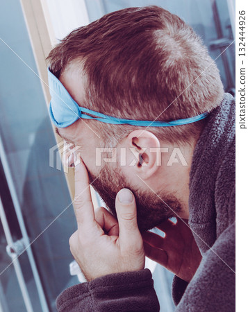 Sleepy man looking at mirror Sleepy man looking at mirror 132444926