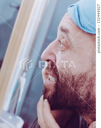 Sleepy man looking at mirror Sleepy man looking at mirror 132444927