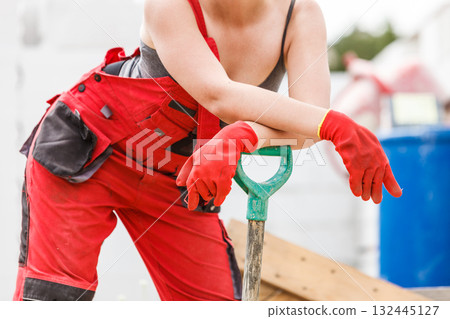 Woman worker with shovel 132445127