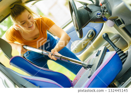 Cleaning car interior with vacuum cleaner Cleaning car interior with vacuum cleaner 132445145