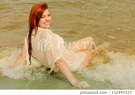 Redhead woman posing in water during summertime 132445523