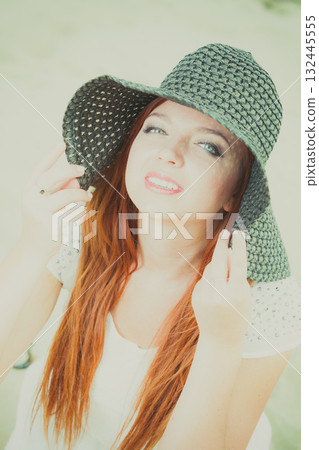 Happy redhead woman wearing big black sun hat Happy redhead woman wearing big black sun hat 132445555