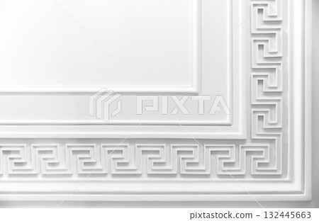 Meander motif over white wall backdrop. Classic moulding pattern, 132445663