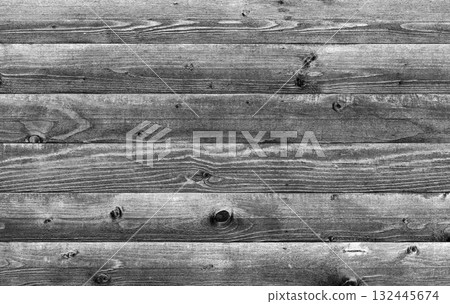 Rustic wooden planks arranged horizontally showcasing natural grains, grayscale 132445674
