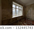 Removing wallpaper from wall during renovation in old room 132445743