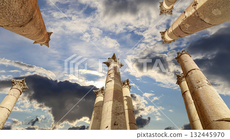 Roman Columns in the Jordanian city of Jerash (Gerasa of Antiquity), capital and largest city of Jerash Governorate, Jordan. Against the background of a beautiful sky with clouds Roman Columns in the Jordanian city of Jerash (Gerasa of Antiquity), capital and largest city of Jerash Governorate, Jordan. Against the background of a beautiful sky with clouds 132445970