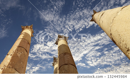 Roman Columns in the Jordanian city of Jerash (Gerasa of Antiquity), capital and largest city of Jerash Governorate, Jordan. Against the background of a beautiful sky with clouds Roman Columns in the Jordanian city of Jerash (Gerasa of Antiquity), capital and largest city of Jerash Governorate, Jordan. Against the background of a beautiful sky with clouds 132445984