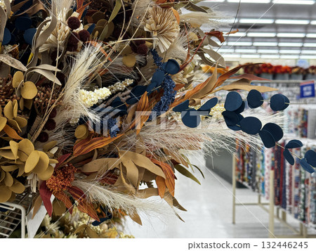 A colorful arrangement of dried and artificial flowers displayed inside a craft supply store A colorful arrangement of dried and artificial flowers displayed inside a craft supply store 132446245