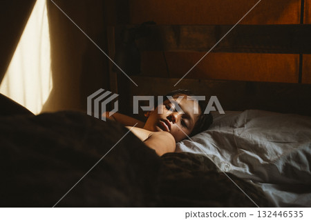 Peaceful Child Sleeping in Warm Morning Light 132446535